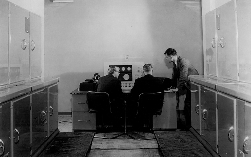 Turing (right) with Ferranti engineers using the Mark I computer in the University