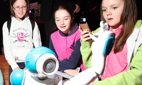 Primary school children observing a robot in action