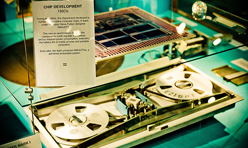 Close-up of computer chips developed in 1990s, housed behind glass in Kilburn Building
