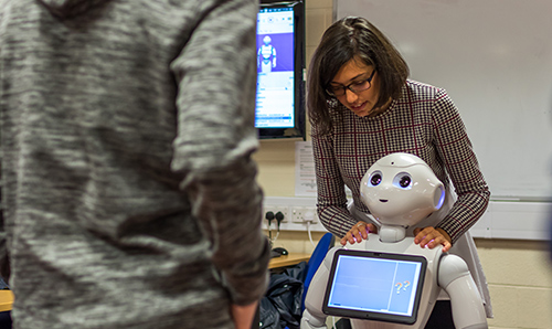 A researcher instructing a robot