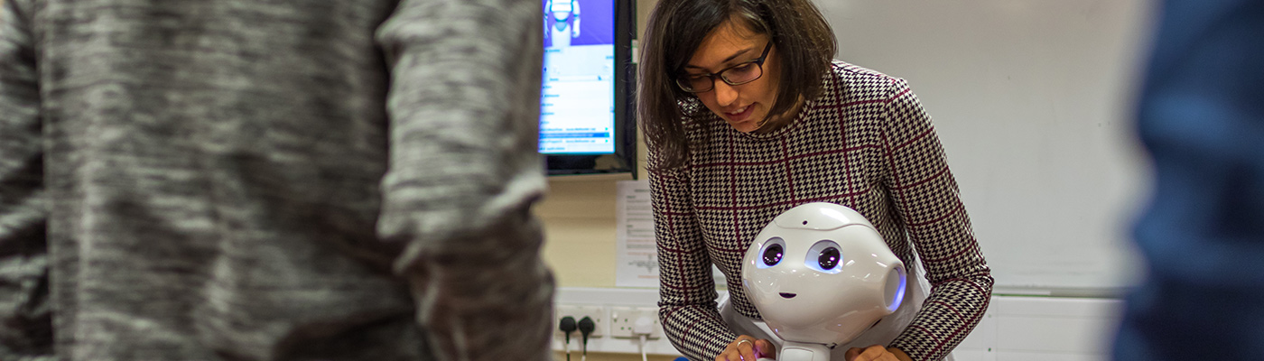 A researcher instructing a robot