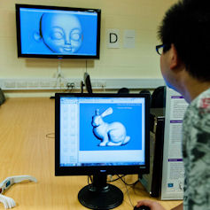 Researcher viewing 3D visualisations on a monitor