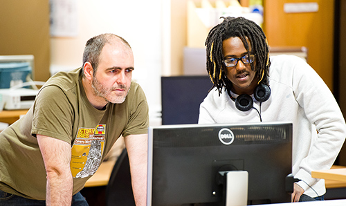 Student and employer observing a computer screen