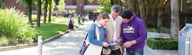 Student advising father and daughter on open day