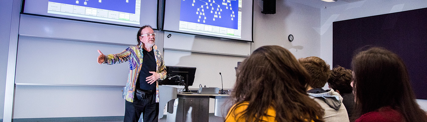 Male lecturer giving a lecture to a group of undergradautes